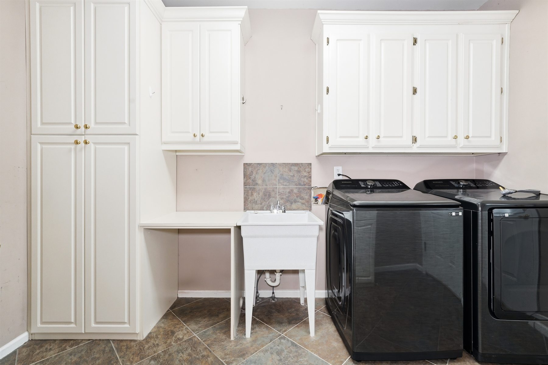Laundry room with storage cabinetry and utility sink