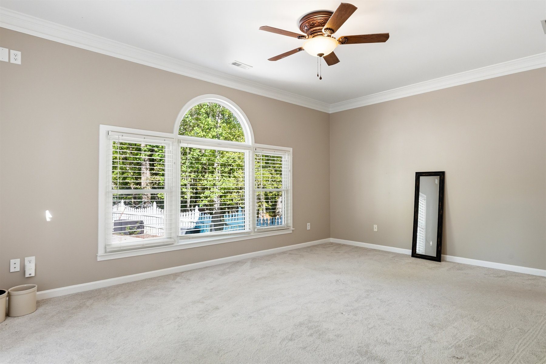 Primary bedroom with oversized arched window