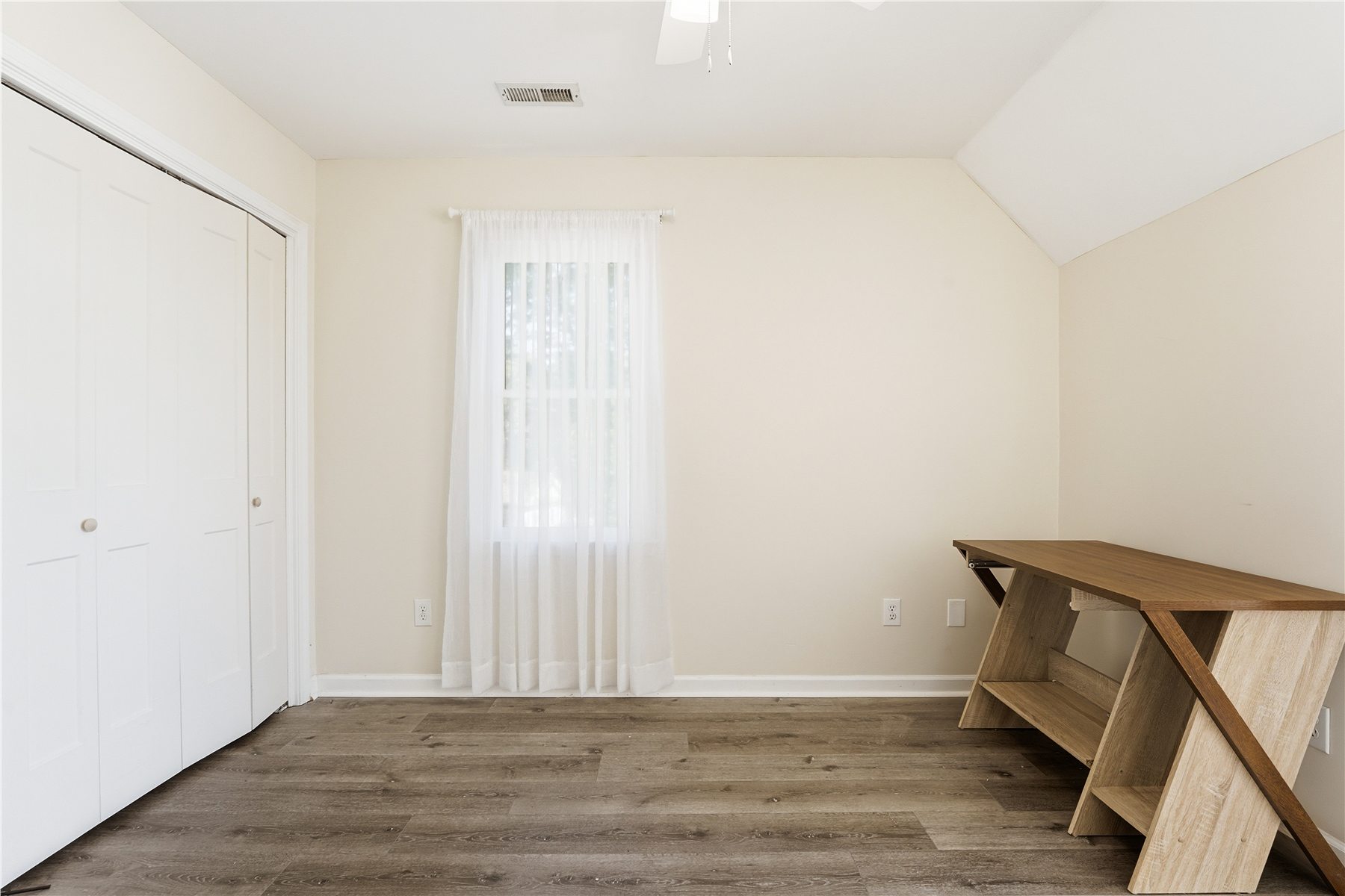 Original upstairs bedroom with desk and closet